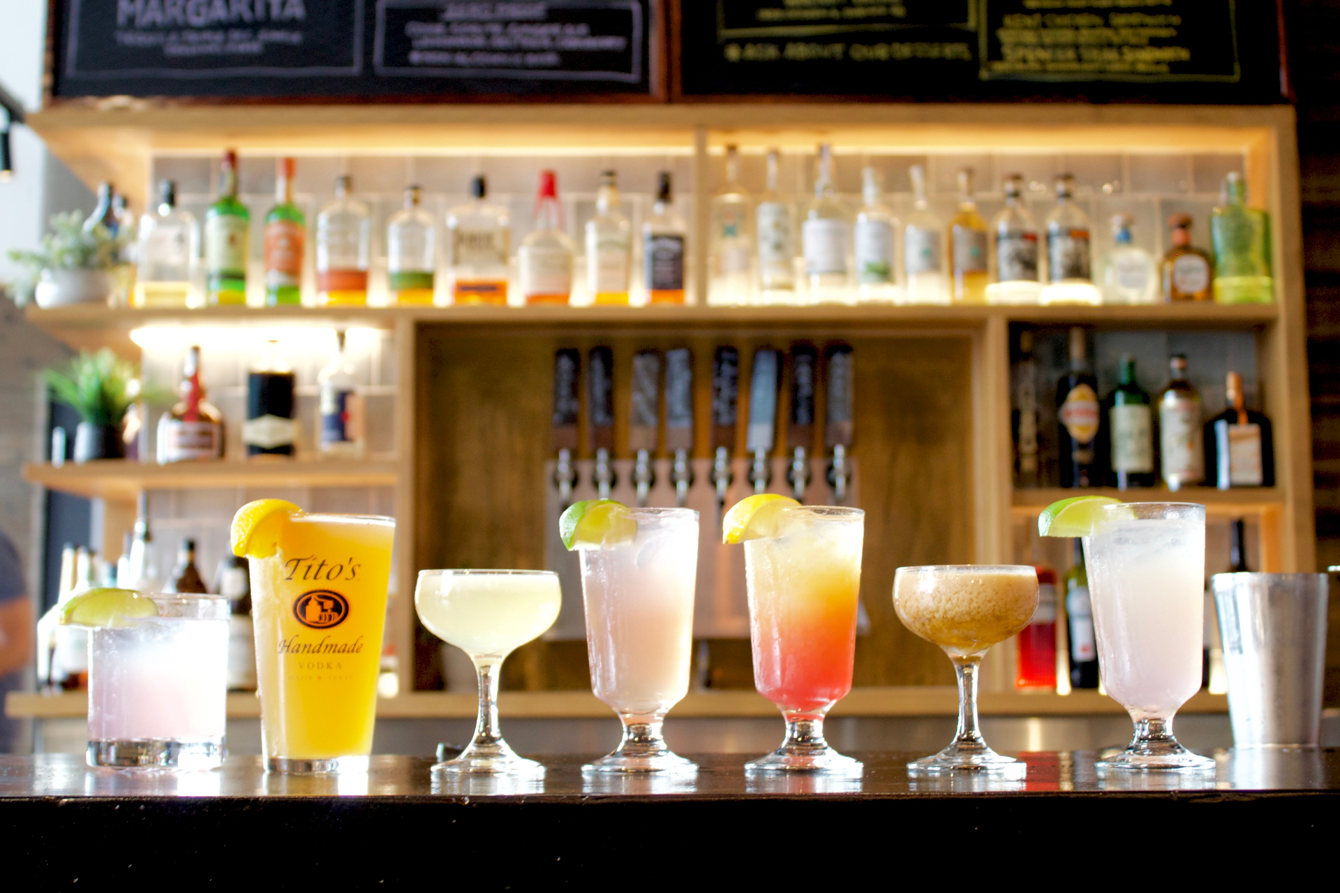 The bar at Rustik Tavern in Brooklyn with cocktails lined up